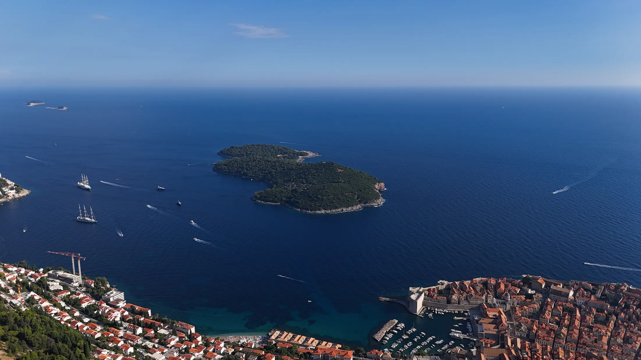 Aerial drone view of Lokrum Island surrounded by blue Adriatic Sea, near Dubrovnik, Croatia