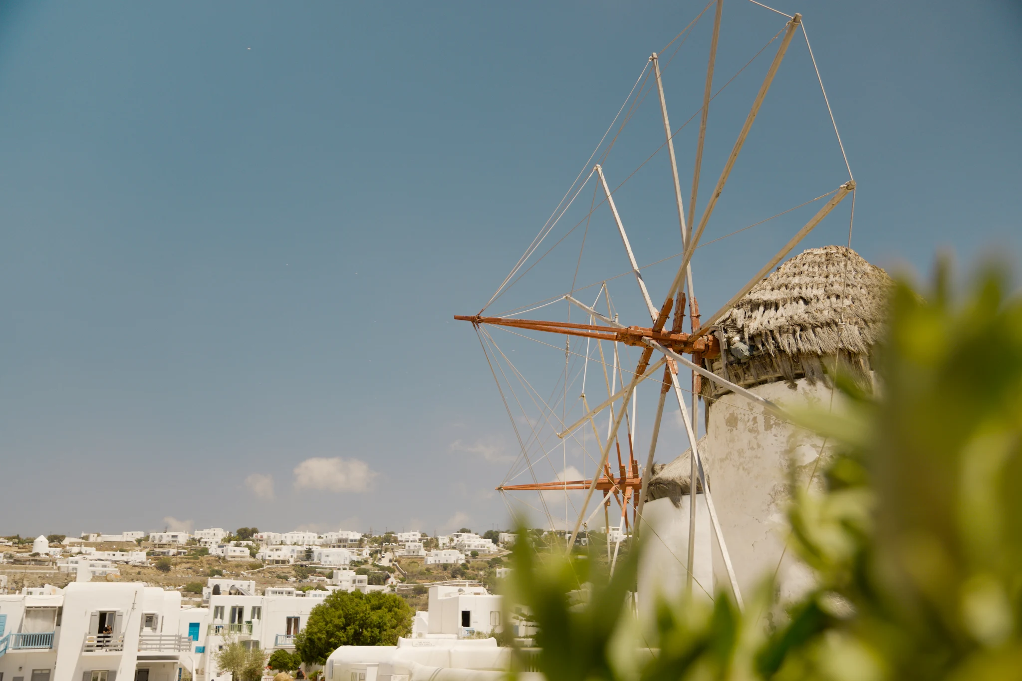 Traditional white windmill against a clear sky in Mykonos, Greece